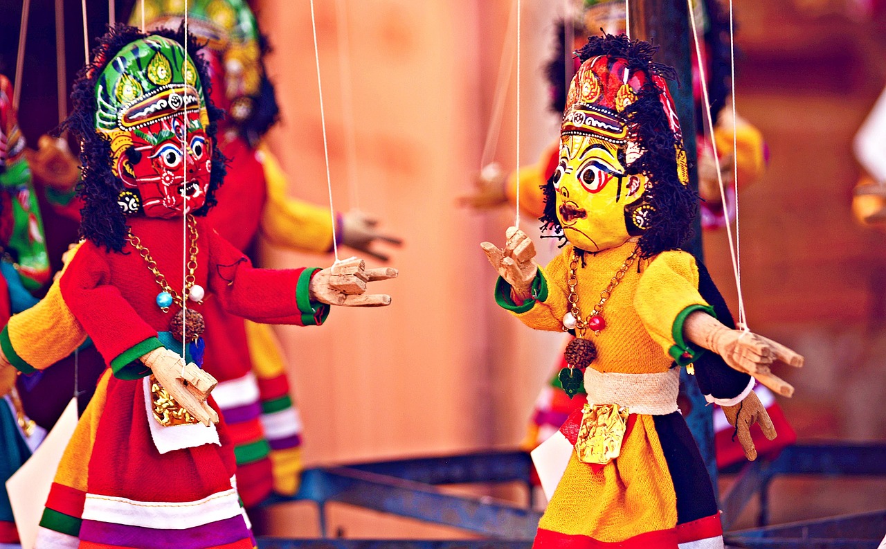 An image of puppets on strings